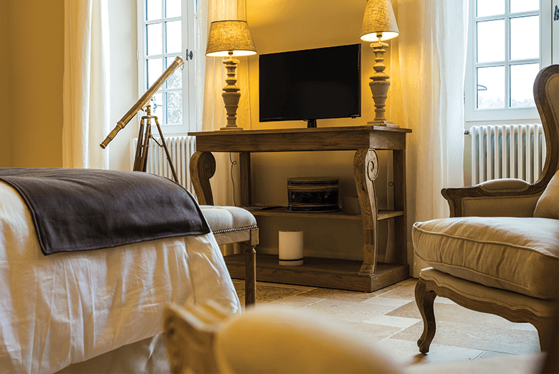 Teintes claires et mobilier en bois apportent élégance et douceur à la chambre Adélaïde au style campagne chic.