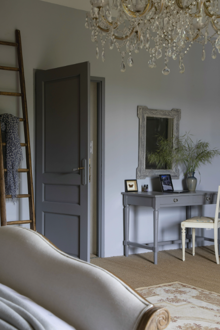 Les teintes de gris de la porte et du bureau apportent un joli contraste aux tons plutôt clairs de la chambre.